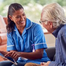 nurse speaking to older male patient