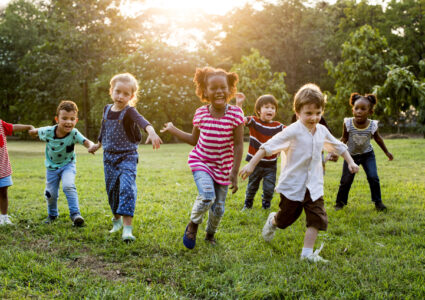 children running outside on grass