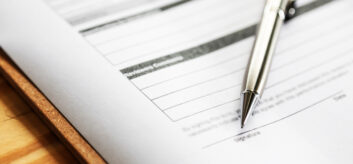 Image of a pen and a referral form.