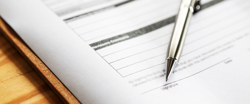 Image of a pen and a referral form.