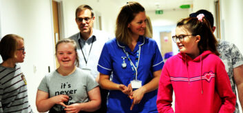 Image of school nurse with children looking happy.