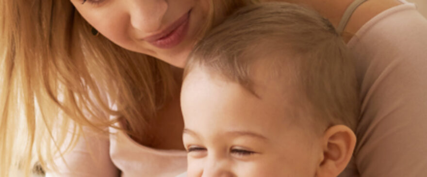 Mum holding her giggling baby